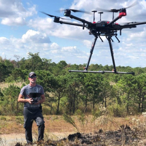 Aspen operator flying a multi-rotor UAV outdoors with a handheld controller